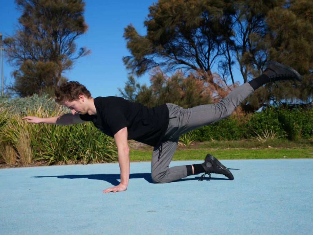 Man doing single arm and single leg raise