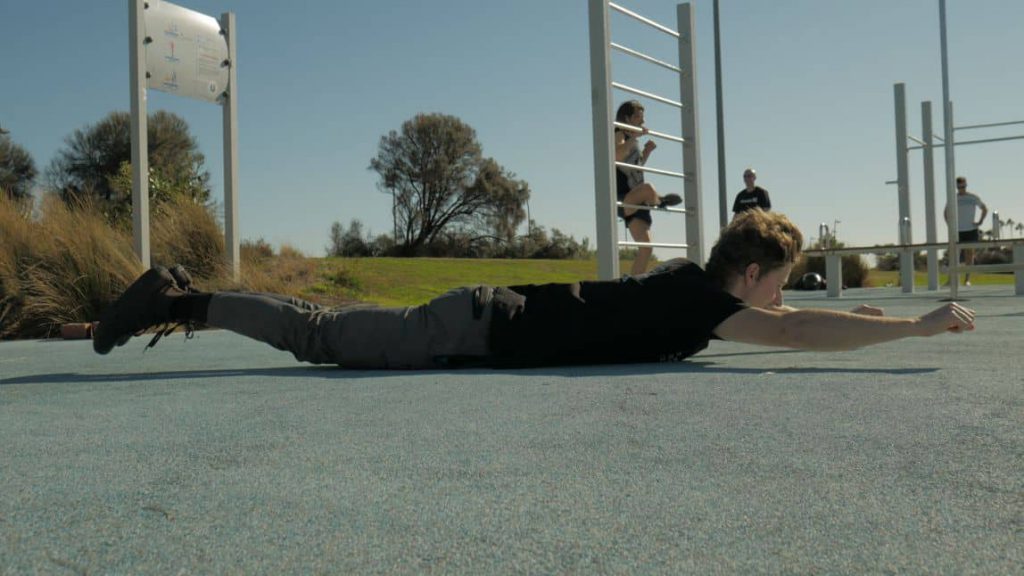 Man doing back exercise superman style