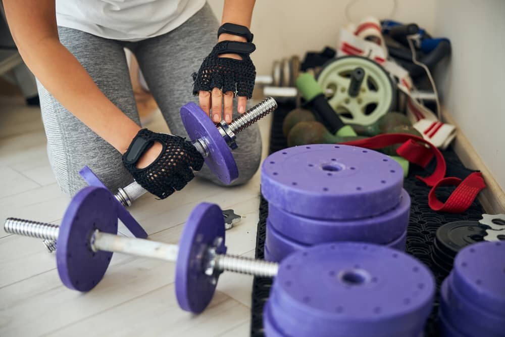 Woman Choosing the Right Load for Dumbbell