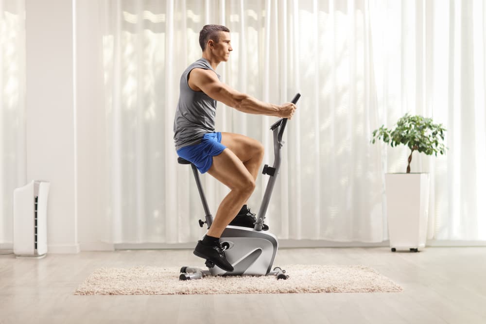 Man riding the stationary bike in his home