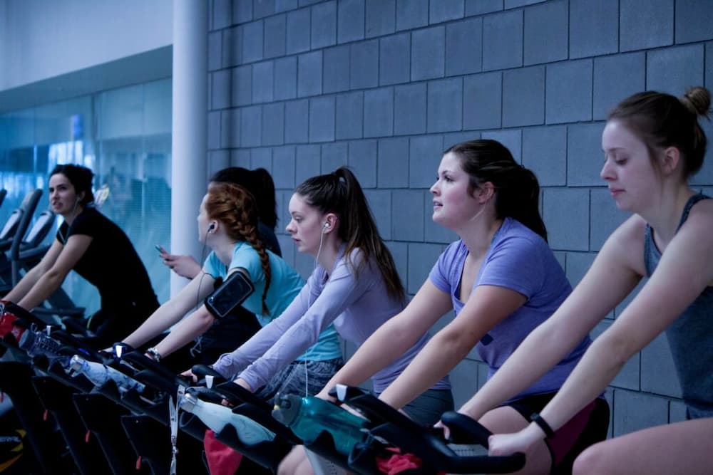 group of women cycling indoors