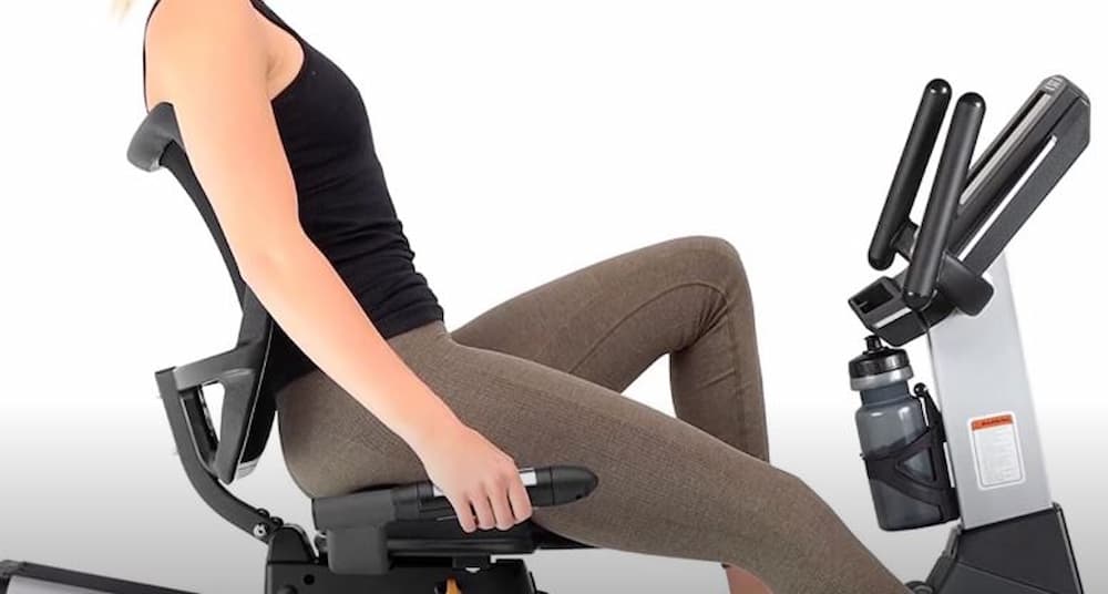 woman warm-up on recumbent bike