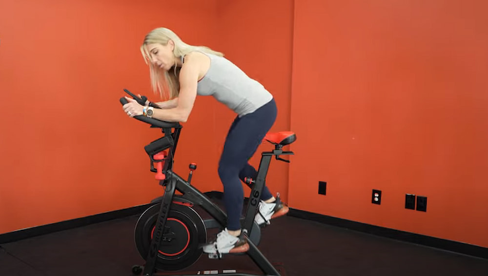 woman explaining cycling tabata workout