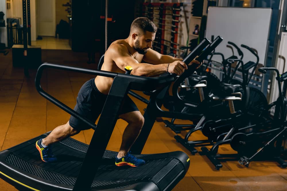 Man Working Out Hard on a Curved Treadmill