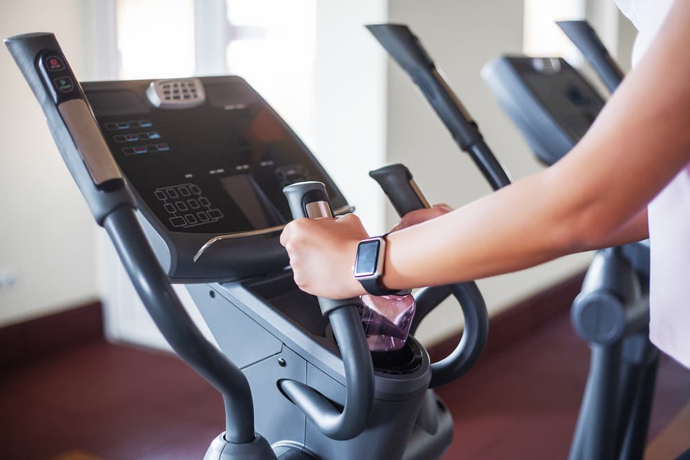 Woman Indoor Cycling with Various Heart Rate Monitors