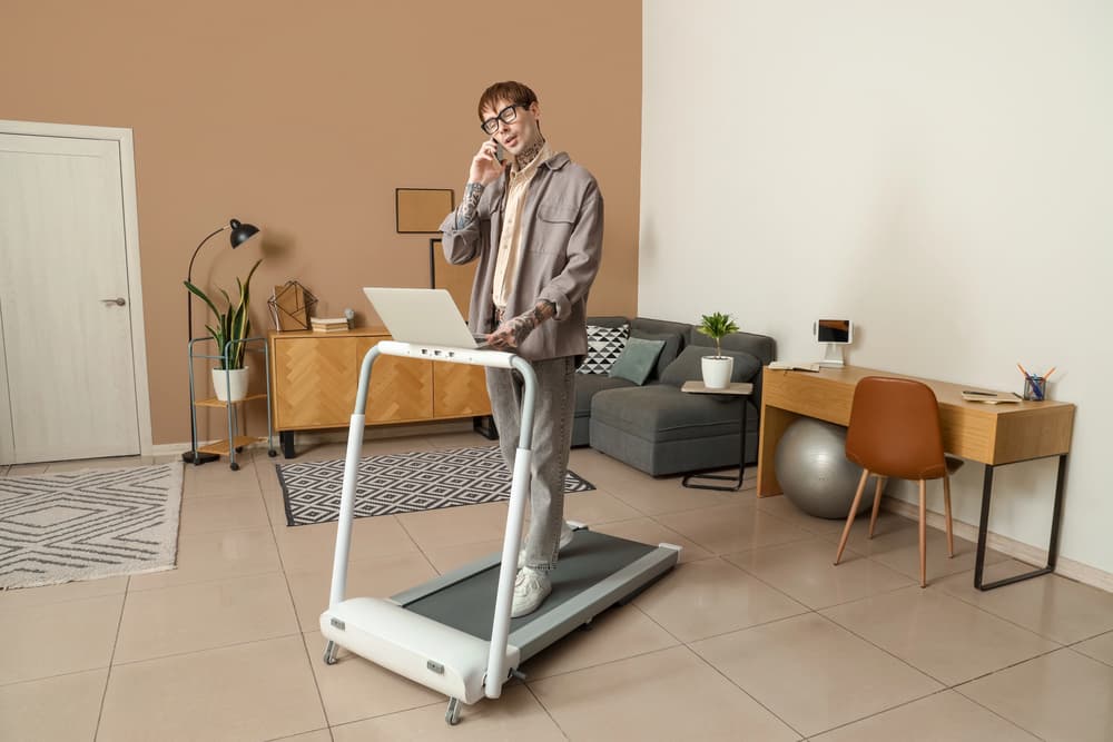 man-working-while-walking-on-treadmill